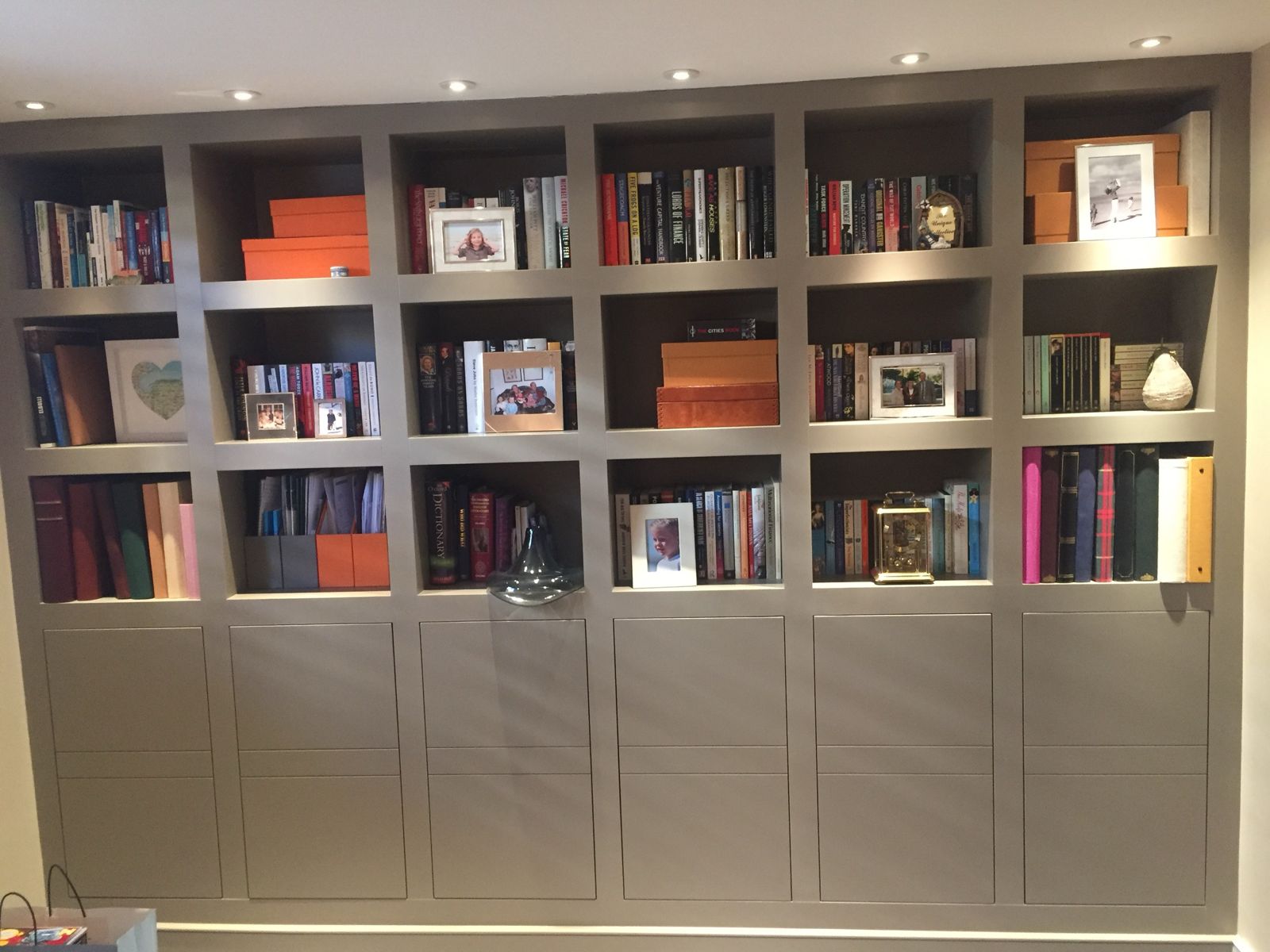 Wall-to-wall painted bookcase with cupboards