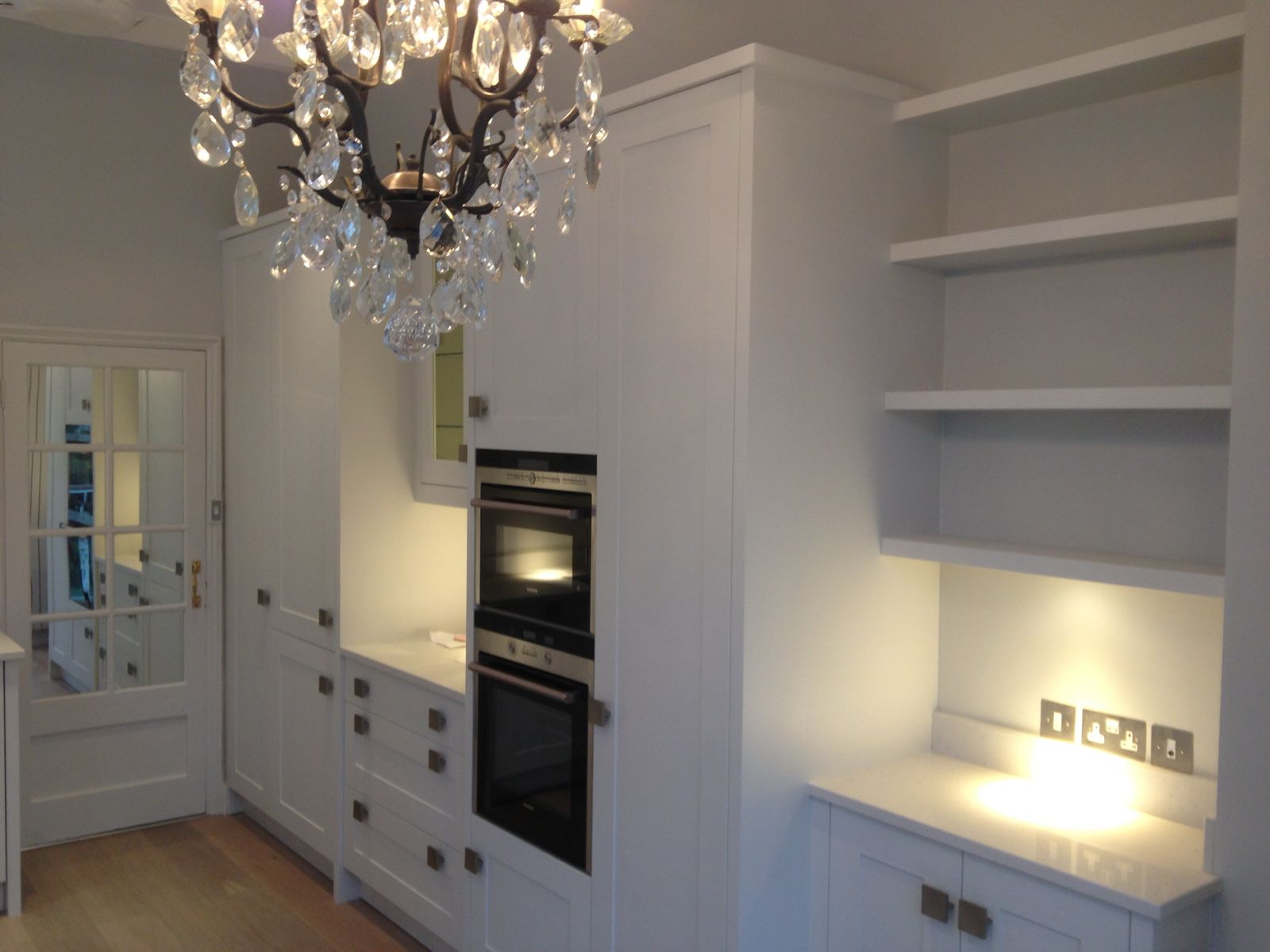 Shaker tall units with ovens and open shelving