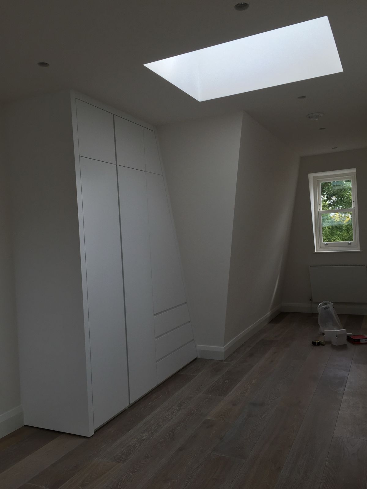 Wide-plank oak floor in a loft bedroom