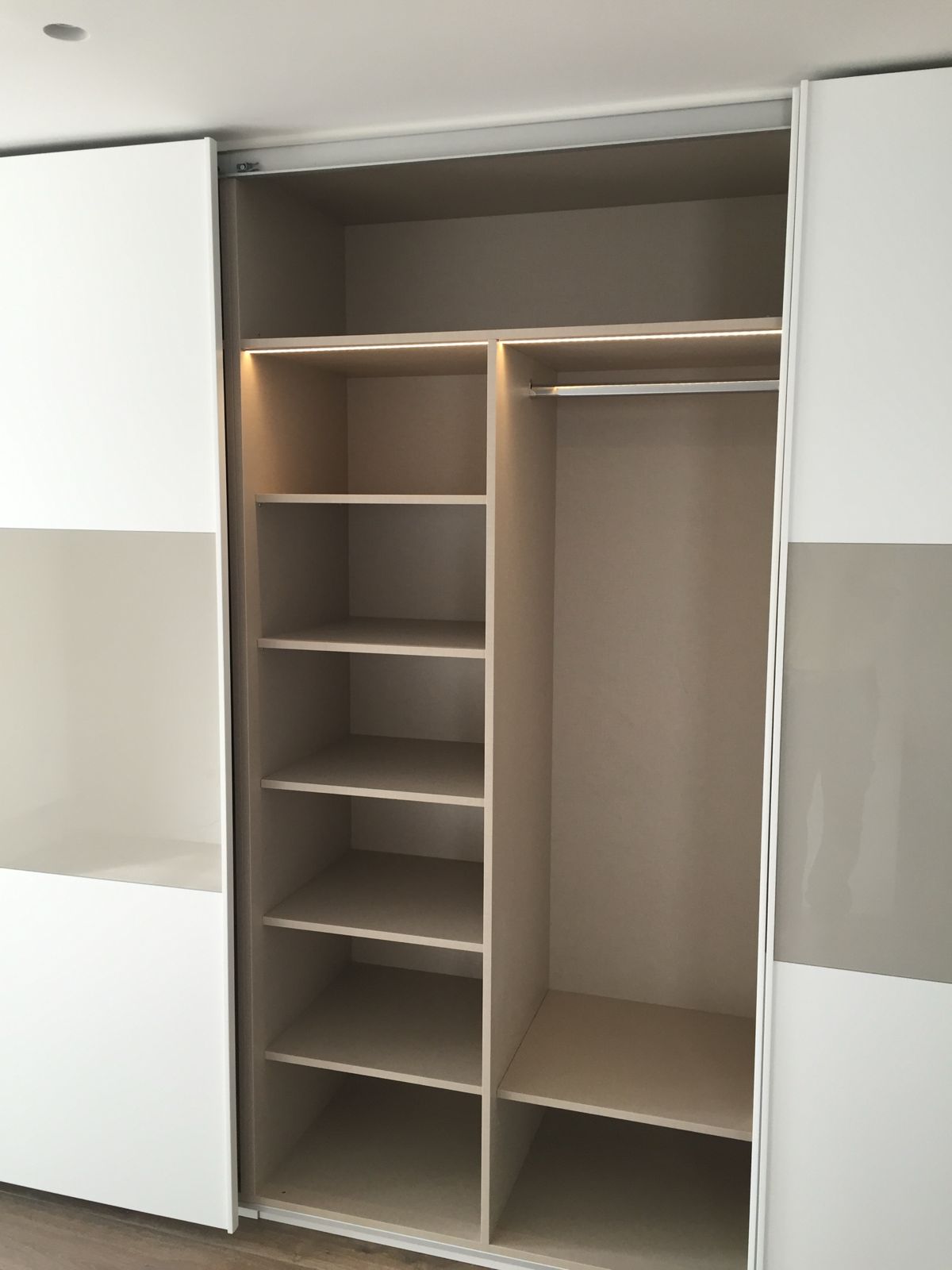 Wardrobe interior with shelves, hanging rail and LED strip
